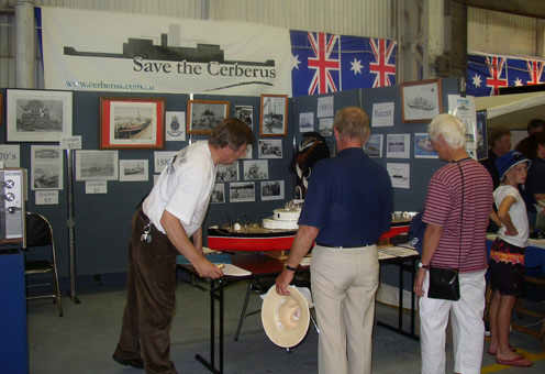 Friends of the Cerberus' webmaster, John Rogers
points out some of the finer features on Robert Schorah's
model of Cerberus at the Williamstown Heritage Boat Show
held over the weekend of 27-28 March 2004.
Photo courtesy of John Toogood.